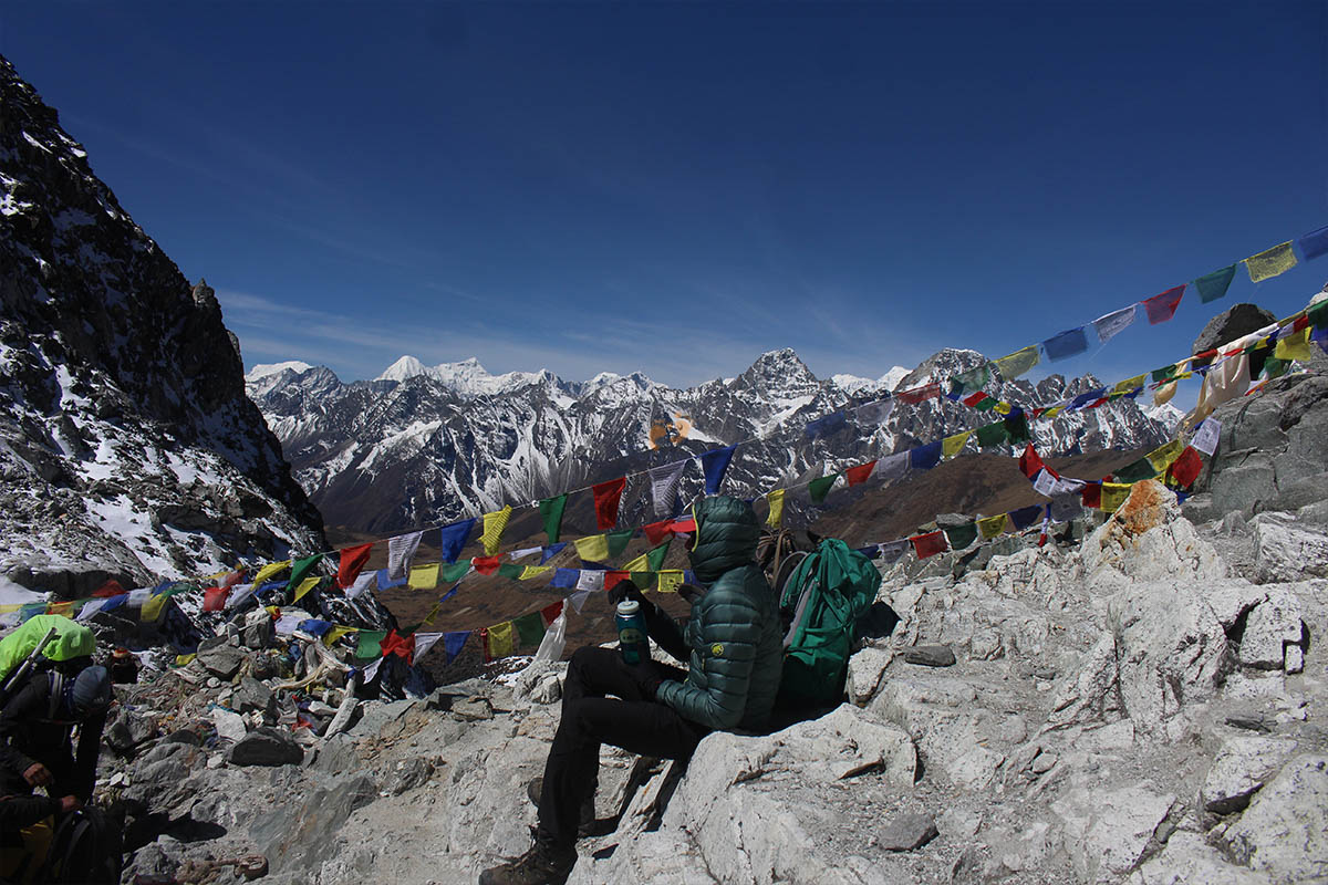 A trekker resting at top of Cho La Pass